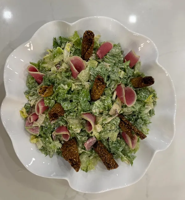 Green salad with watermelon radish and crisp toasts